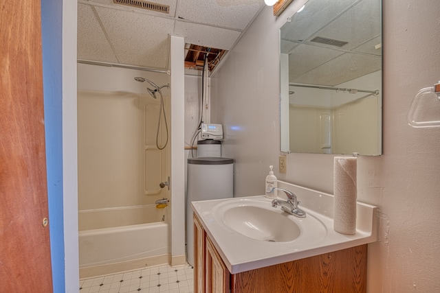 bathroom with vanity, a drop ceiling, and shower / bathtub combination