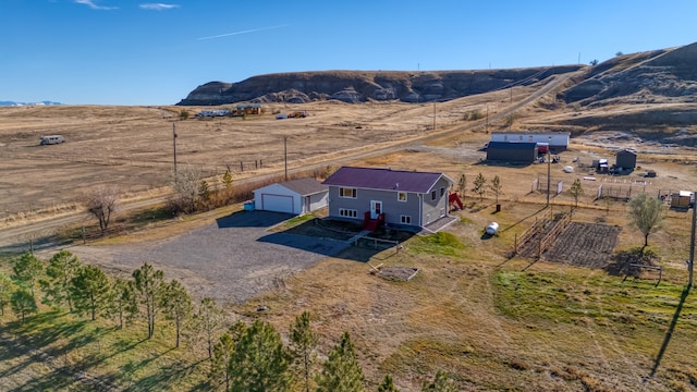 bird's eye view featuring a rural view and a mountain view