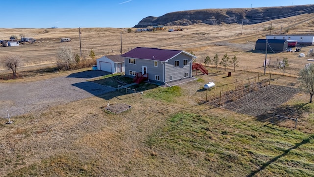 birds eye view of property with a mountain view and a rural view