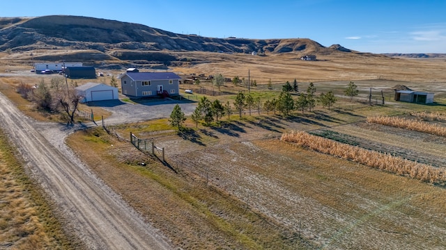 birds eye view of property with a mountain view and a rural view