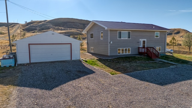 exterior space featuring a garage, a mountain view, and an outdoor structure