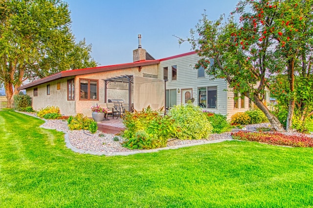 rear view of property featuring a lawn and a pergola