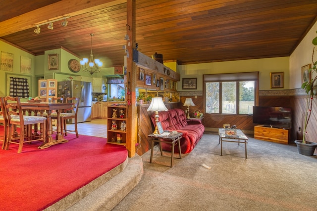 living room with an inviting chandelier, wooden ceiling, vaulted ceiling, carpet, and wood walls