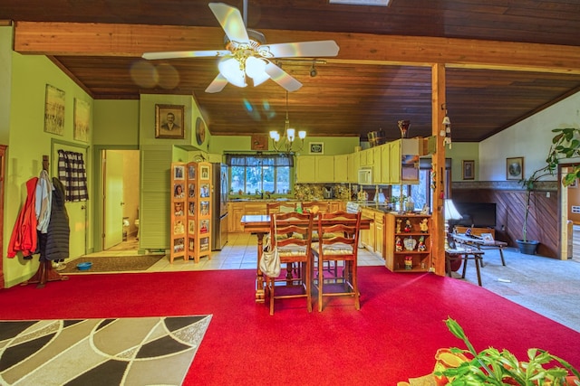 dining room featuring vaulted ceiling with beams, ceiling fan, light carpet, and wooden ceiling