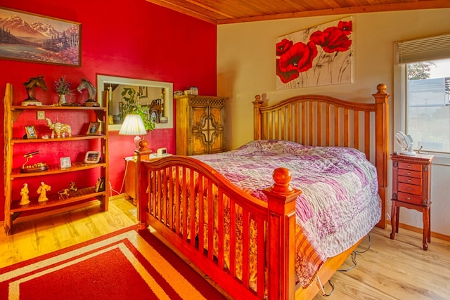 bedroom featuring wooden ceiling, vaulted ceiling, and light hardwood / wood-style flooring