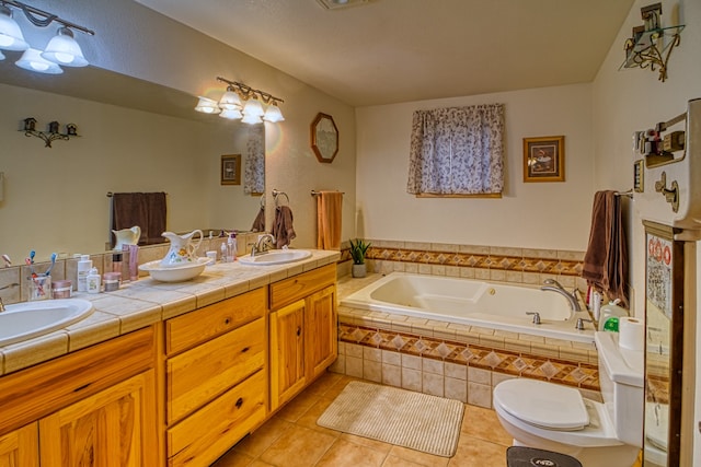 bathroom with vanity, toilet, a relaxing tiled tub, and tile patterned flooring