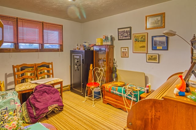 rec room with light carpet and a textured ceiling