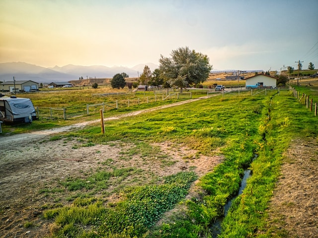 view of yard with a mountain view and a rural view