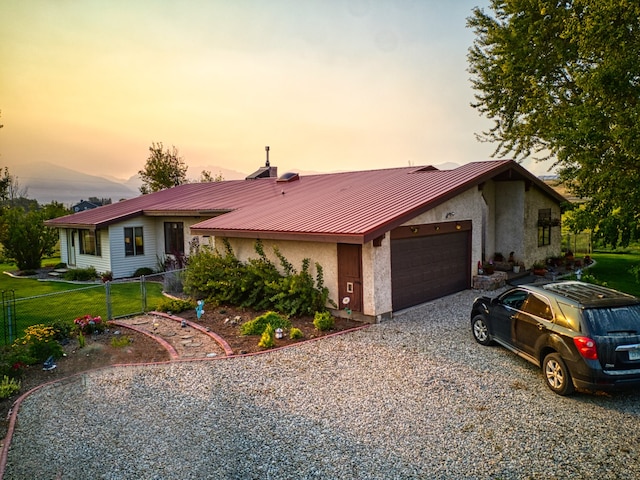 ranch-style house featuring a yard and a garage