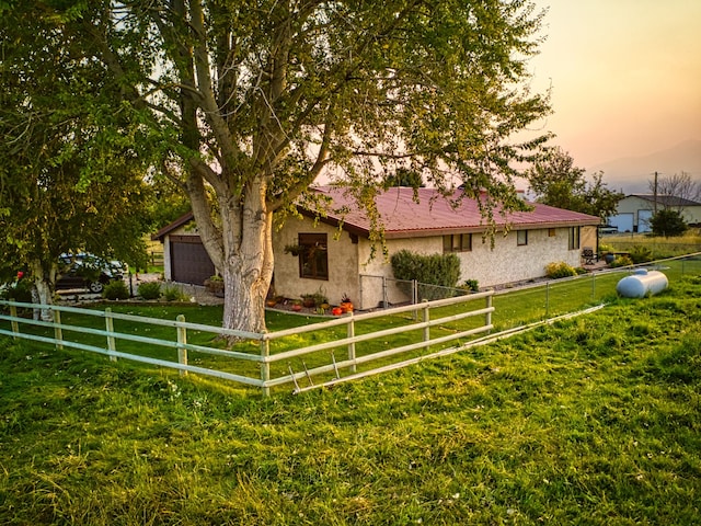 property exterior at dusk with a lawn