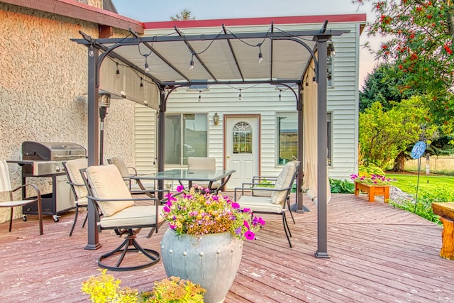 deck with area for grilling and a pergola