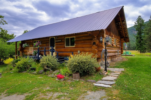 510 Johnson Ln, Superior, MT 59872 - back of house with log exterior, a yard, and metal roof