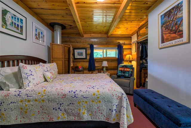 510 Johnson Ln, Superior, MT 59872 - carpeted bedroom featuring wooden ceiling, beam ceiling, wood walls, and a walk in closet