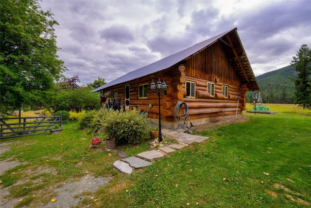 510 Johnson Ln, Superior, MT 59872 - view of home's exterior featuring log siding, a lawn, and metal roof