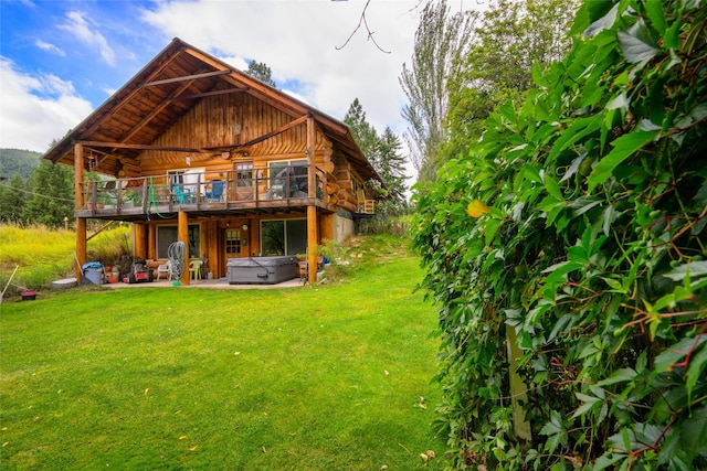 510 Johnson Ln, Superior, MT 59872 - back of property featuring a hot tub, log siding, a deck, a yard, and a patio