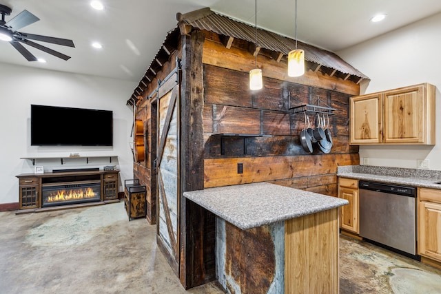 kitchen featuring decorative light fixtures, light brown cabinetry, ceiling fan, stainless steel dishwasher, and a barn door