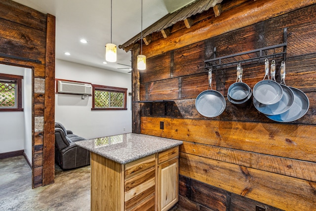 kitchen featuring a wall mounted AC, concrete floors, and decorative light fixtures