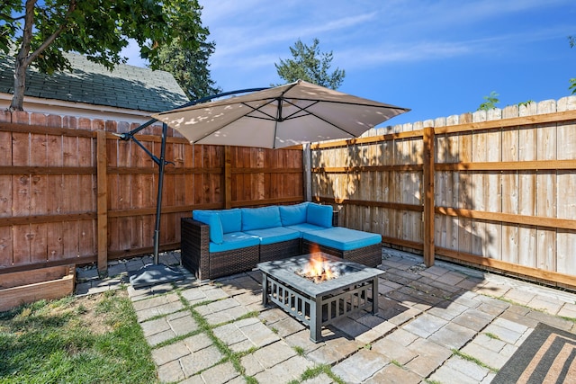 view of patio / terrace with an outdoor living space with a fire pit