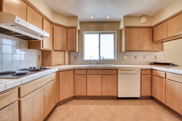 kitchen featuring sink, decorative backsplash, white appliances, tile countertops, and extractor fan