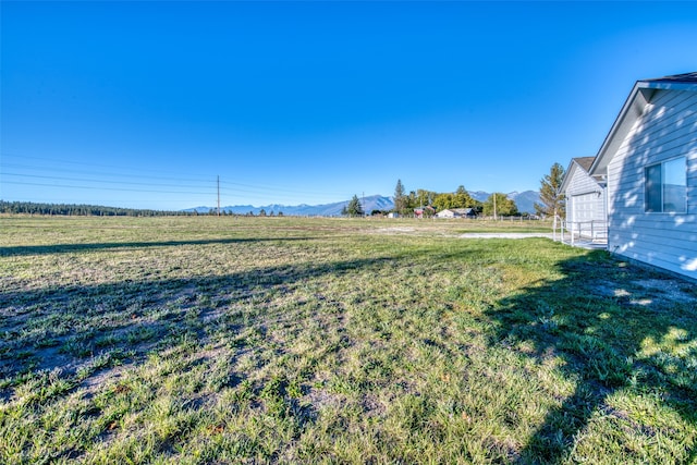 view of yard featuring a mountain view and a rural view