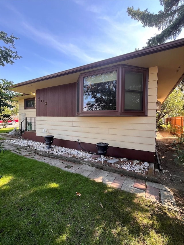 view of side of home featuring a lawn