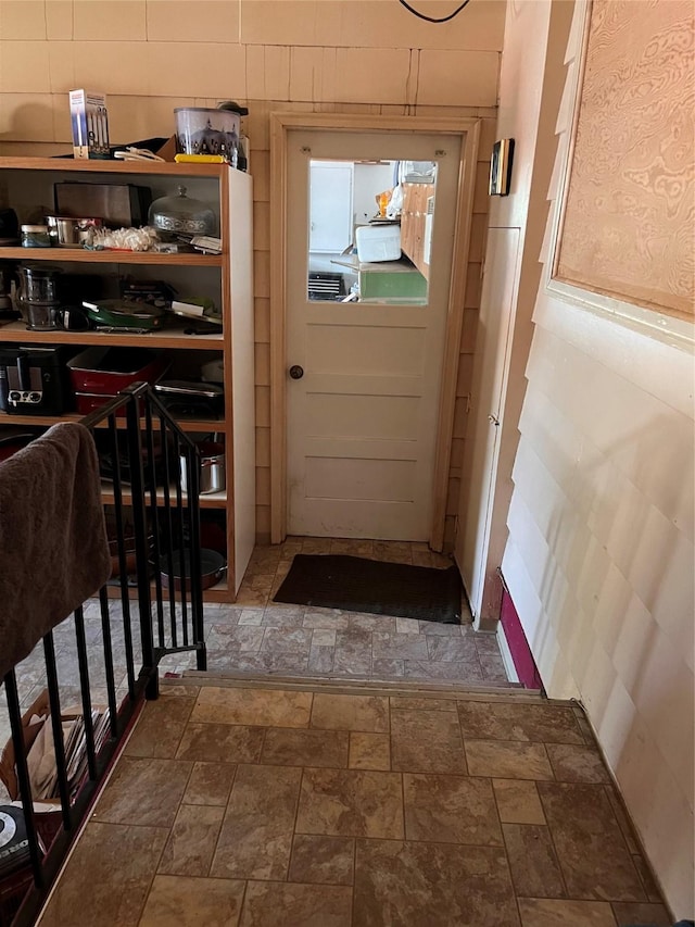 entryway featuring stone finish floor