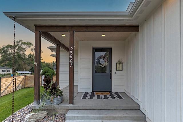 exterior entry at dusk featuring a porch