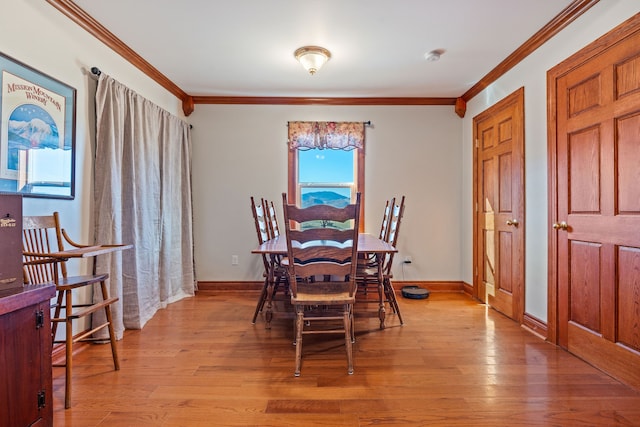 dining area with hardwood / wood-style flooring, plenty of natural light, and ornamental molding