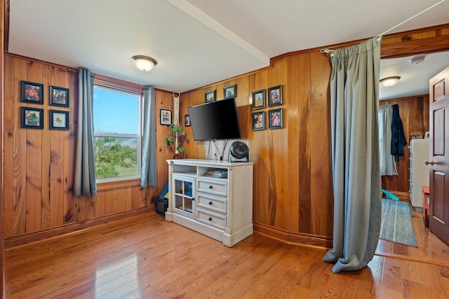 interior space featuring wood walls and light hardwood / wood-style floors