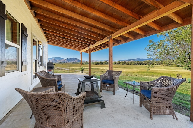 view of patio featuring a rural view and a mountain view