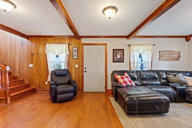 living room featuring wood walls, wood-type flooring, and beamed ceiling