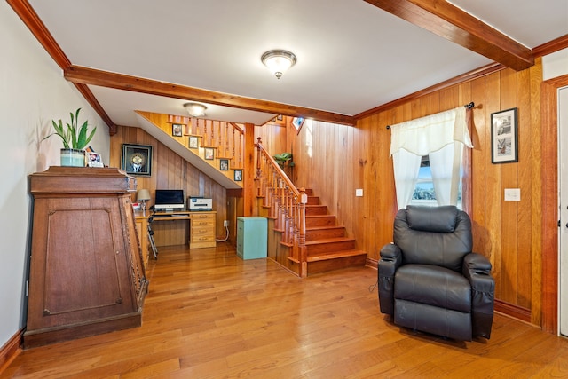 foyer featuring crown molding, wood walls, beam ceiling, and hardwood / wood-style flooring