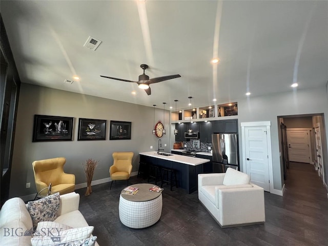 living room with dark wood-type flooring, sink, and ceiling fan