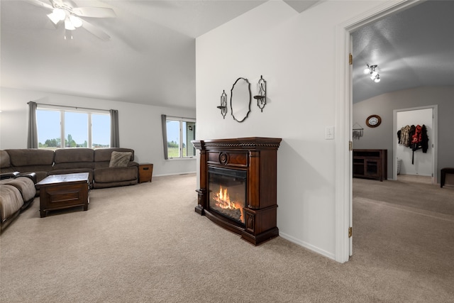 living room featuring light carpet, ceiling fan, and vaulted ceiling