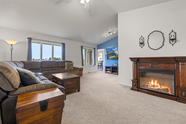 carpeted living room with ceiling fan, track lighting, and vaulted ceiling