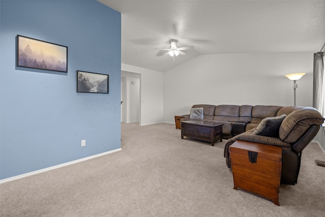 carpeted living room with ceiling fan and vaulted ceiling