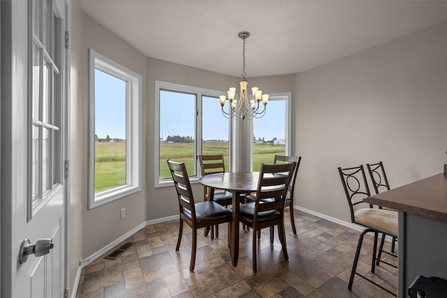 125 Ponderosa Ln, Kalispell, MT 59901 - dining area with stone tile floors and a chandelier