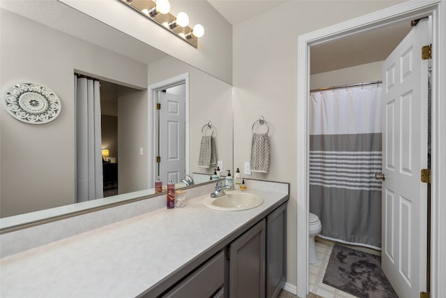 bathroom featuring a shower with curtain, tile patterned floors, vanity, and toilet