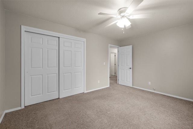 unfurnished bedroom with a closet, light carpet, and ceiling fan