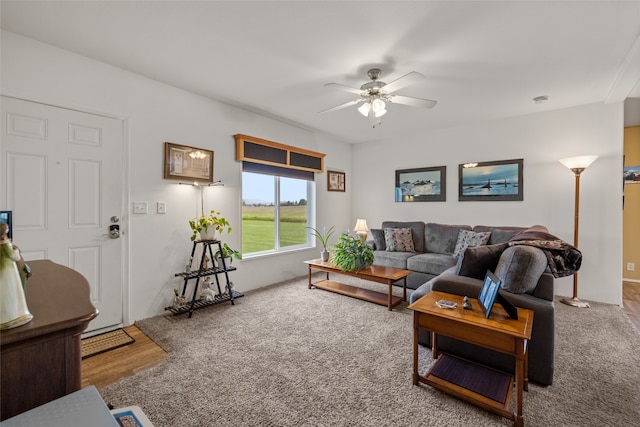 living room featuring hardwood / wood-style floors and ceiling fan