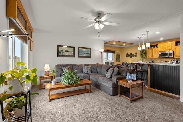 carpeted living room featuring ceiling fan