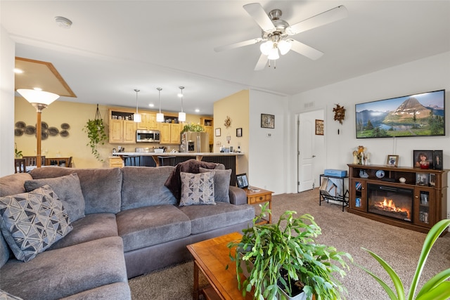 living room featuring ceiling fan and carpet flooring