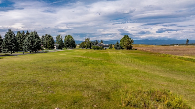 surrounding community with a yard, a mountain view, and a rural view