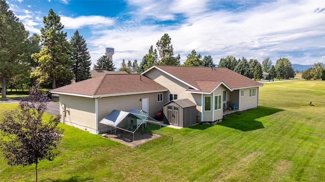 rear view of property with a storage shed and a lawn