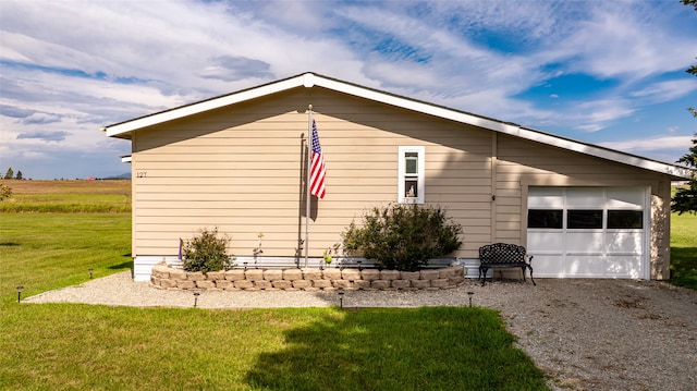 view of side of property with a lawn and a garage