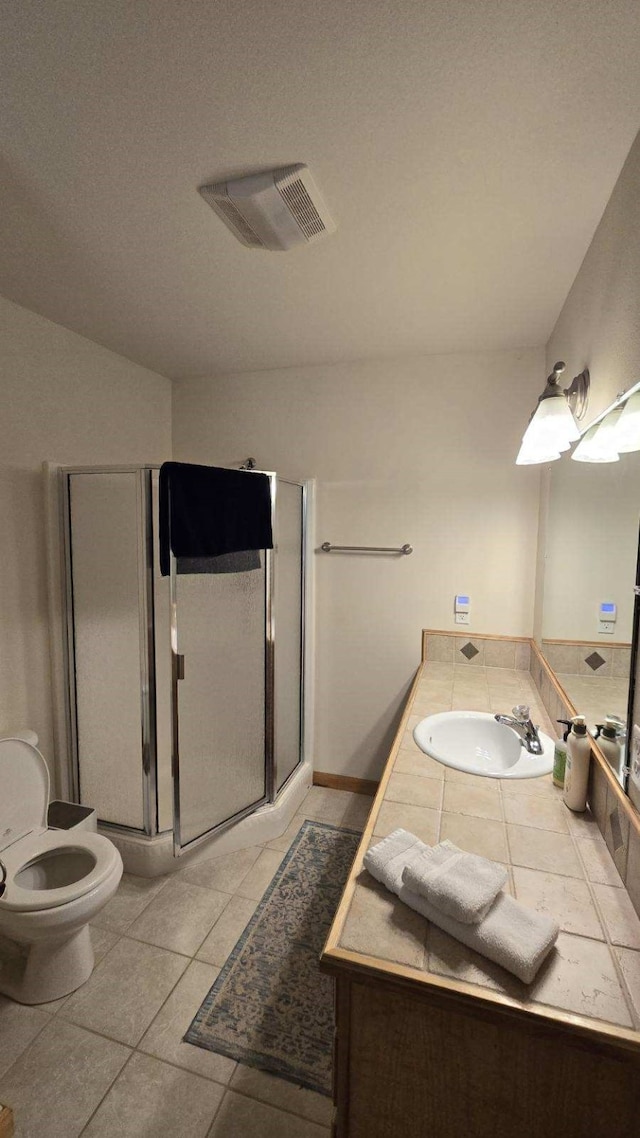 bathroom featuring tile patterned flooring, toilet, an enclosed shower, and vanity