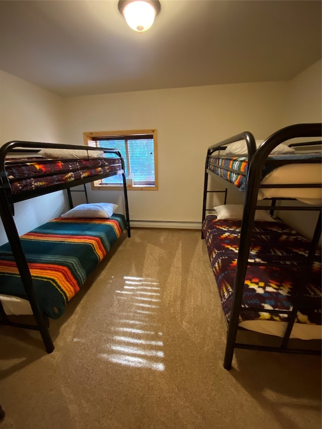 carpeted bedroom featuring a baseboard heating unit