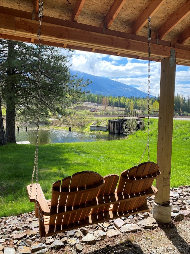 exterior space with a water and mountain view