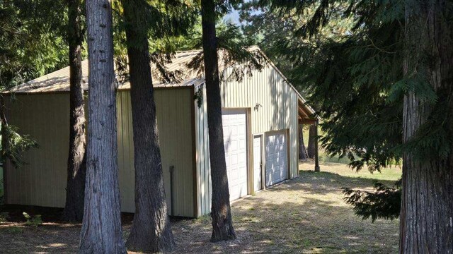 view of side of property featuring a garage and an outdoor structure