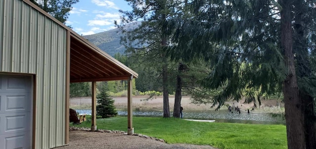 surrounding community with a yard and a water and mountain view